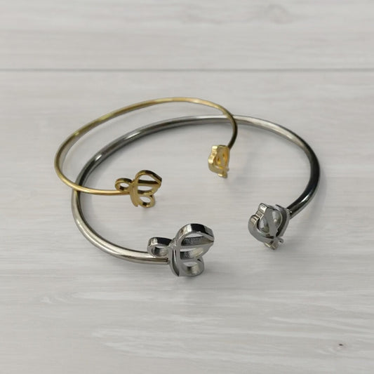 The Sikh Khanda Bangle Bracelets are a stunning representation of cultural pride and elegant fashion. Featuring the revered Ek Onkar and Khanda symbols, these bracelets are available in both gold and silver finishes, catering to different style preferences. They offer a unique blend of traditional symbolism and modern design, making them suitable for both everyday wear and special occasions. The design of the Sikh Khanda Bangle Bracelets is both sophisticated and meaningful.