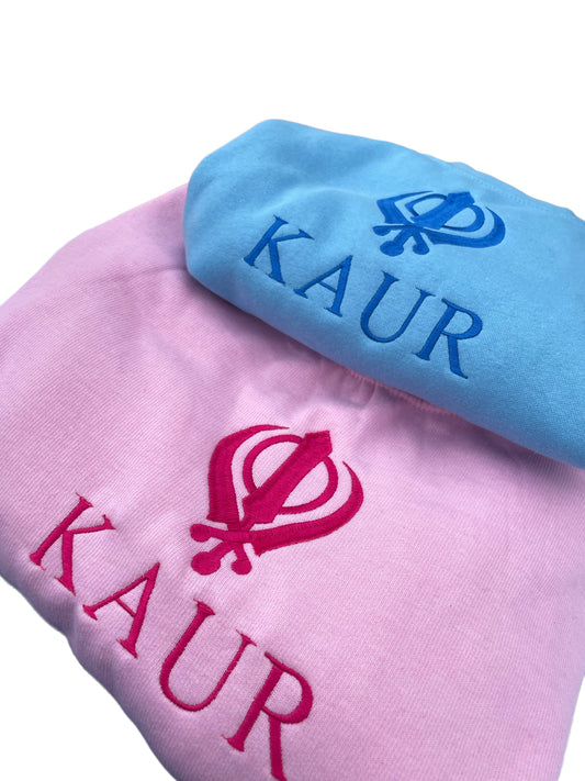 The embroidered KAUR sweater is available in Blue or Pink fabric. Perfect for any young Kaur wanting to incorporate their love of Sikhi with everyday fashion. The intricate embroidery adds a touch of elegance to this cozy piece, making it both stylish and comfortable.