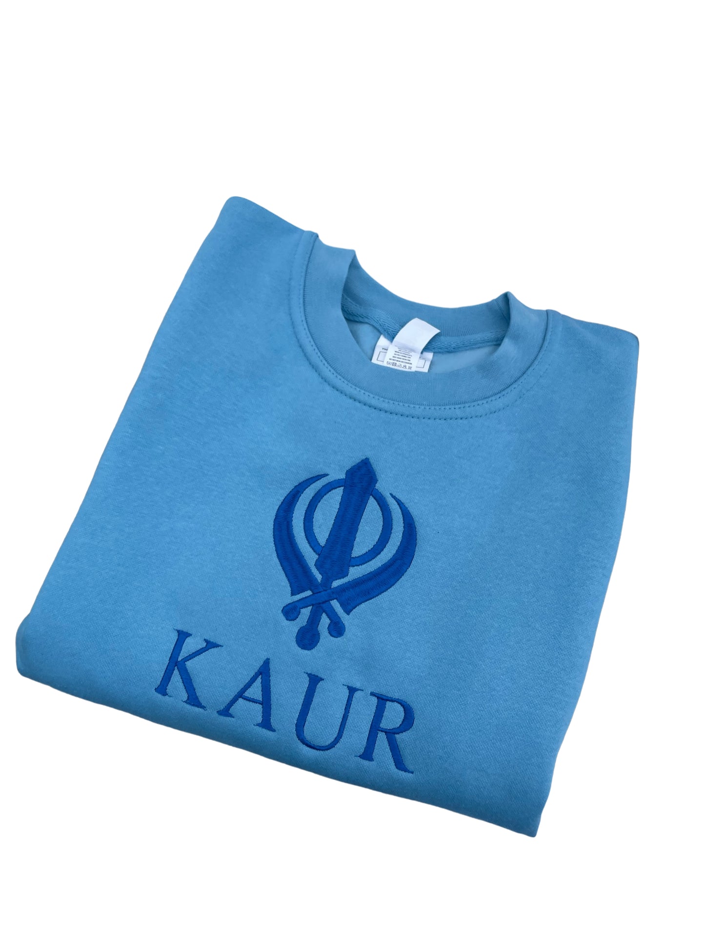 The embroidered KAUR sweater is available in Blue or Pink fabric. Perfect for any young Kaur wanting to incorporate their love of Sikhi with everyday fashion. The intricate embroidery adds a touch of elegance to this cozy piece, making it both stylish and comfortable. 